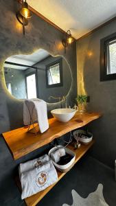 a bathroom with a sink and a mirror at Cabana Canto do Bugio in Gramado