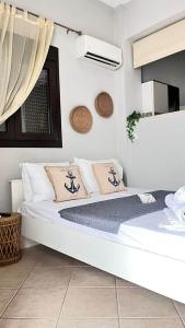 a bedroom with a large white bed with pillows at Sweet Studio in Leptokarya