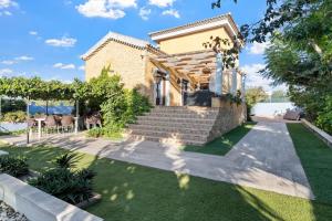 a villa with a staircase leading to a house at Ca Marga in Santa Pola