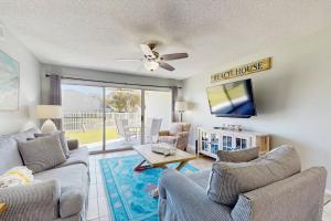a living room with two couches and a tv at Maravilla 1114 in Destin