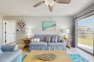 a living room with a couch and a table at Maravilla 1114 in Destin +23 photos