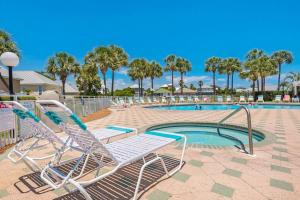 a pool with two lounge chairs next to a swimming pool at Maravilla 1114 in Destin