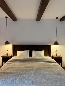 a bedroom with a large bed with two night stands at Festung 57 in Bran