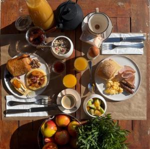 a table topped with plates of breakfast foods and drinks at CÉRÈS - Boutique-Hôtel & Spa - Élégance en Terre d'Uzès in Saint-Quentin-la-Poterie +191 photos