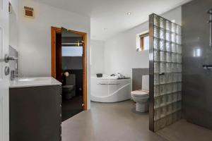 a bathroom with a toilet and a sink and a tub at 0344-Romo-Vestergade-331 in Høm +31 photos