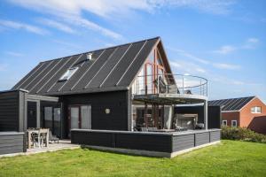 a black house with a metal roof at 0344-Romo-Vestergade-331 in Høm