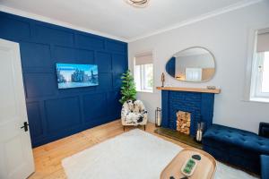 a living room with a blue wall at Limefield Residence in West Calder
