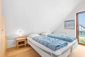 a bedroom with two beds and a window at 0343-Romo-Vestergade-329 in Høm