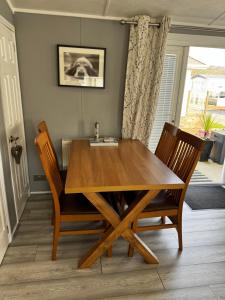 a dining room table with two chairs and a sink at 21 Hesket Park HUGE HOT TUB Pet friendly No Commercial Vans in High Hesket