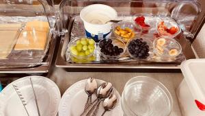 a table with plates and bowls of fruits and vegetables at Hotel Heynen in Valkenburg
