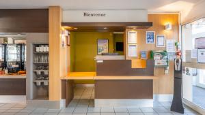 a restaurant with a counter in a store at Kyriad ECO - Lorient Lanester in Lanester