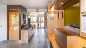 a hallway of a hospital with a counter and a room at Kyriad ECO - Lorient Lanester in Lanester