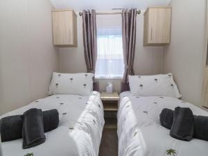 two beds sitting next to each other in a room at Pheasant Lodge in Holyhead