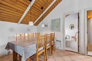 a dining room with a table and chairs at 0152-Romo-Ejnar-Mikkelsensvej-5 in Høm