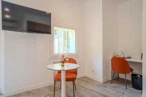 a dining room with a table and two chairs at Italianflat - Vandom 2 Duomo Luxury Rooms Foresteria Lombarda in Milan +20 photos