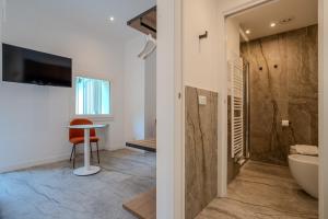 a bathroom with a tub and a toilet and a sink at Italianflat - Vandom 2 Duomo Luxury Rooms Foresteria Lombarda in Milan