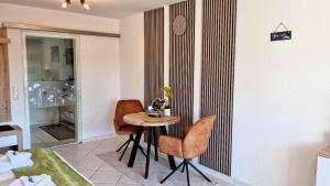 a dining room with a table and two chairs at Ferienwohnung Naturgenuss in Oy-Mittelberg