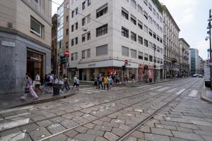 a group of people walking on a city street at Italianflat - Vandom 2 Duomo Luxury Rooms Foresteria Lombarda in Milan
