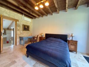 a bedroom with a bed and a desk in a room at Clos de La Brelaisière in Chauvigny +12 photos