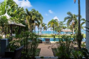 a resort with a swimming pool and palm trees at Beachfront! 2 Bedroom Apartment A4 - 110 Sqm in Ko Bu Bu +35 photos