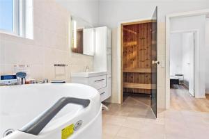 a white bathroom with a sink and a mirror at 0342-Romo-Vestergade-355 in Høm +14 photos