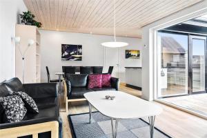 a living room with a couch and a table at 0342-Romo-Vestergade-355 in Høm