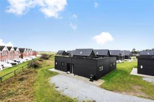 an aerial view of a house with black roofs at 0342-Romo-Vestergade-355 in Høm