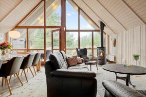 a living room with a couch and chairs and a table at 0212-Romo-Lejrbjergvej-24 in Høm