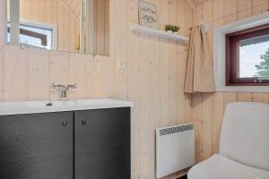 a bathroom with a sink and a toilet and a window at 0212-Romo-Lejrbjergvej-24 in Høm +23 photos
