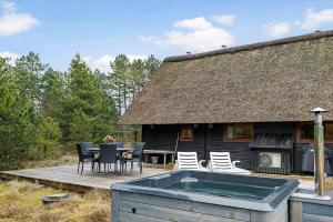 a house with a hot tub in front of it at 0212-Romo-Lejrbjergvej-24 in Høm