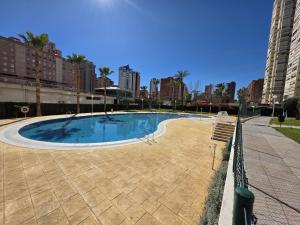 an empty swimming pool in a city with tall buildings at Apartamento Luxury Views IF Benidorm in Benidorm