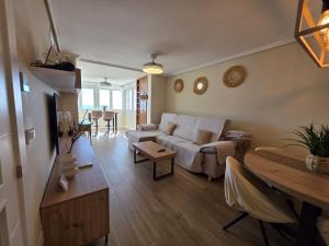 a living room with a couch and a table at Apartamento Luxury Views IF Benidorm in Benidorm