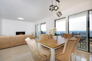 a dining room with a table and chairs at Sunset Apartments in Makarska