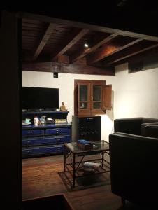 a living room with a couch and a table at Namasté Casa Rural in Vaqueros