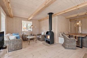 a living room with a wood stove in it at 0145-Romo-Hattesvej-36 in Høm