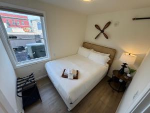 a small bedroom with a bed and a window at The Global Getaway in St. Charles