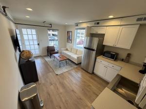 a kitchen and living room with white cabinets at The Global Getaway in St. Charles