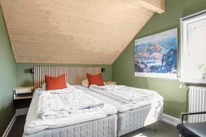 two beds in a room with green walls at 0442-Romo-Vestergade-137-Ap-101 in Høm +35 photos