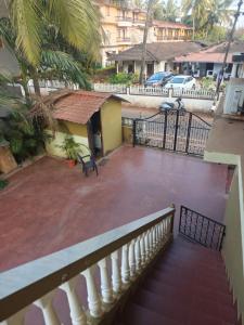 a balcony of a building with a table and a bench at Carvalhos Regina 100 mtrs Patnem beach in Canacona