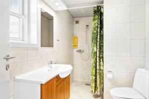 a bathroom with a sink and a toilet and a shower at 0227-Romo-Kromosevej-17 in Høm