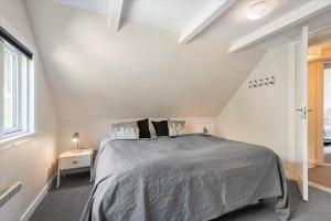 a bedroom with a large bed in a attic at 0172-Romo-Rabjergvej-84 in Høm