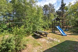 a park with a playground with a bench and a swing at 0172-Romo-Rabjergvej-84 in Høm