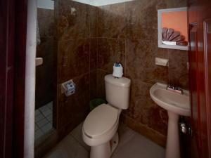 a bathroom with a toilet and a sink at Royal Pacífico Manzanillo in Manzanillo