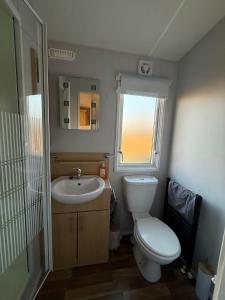 a bathroom with a toilet and a sink and a mirror at FarmaKolonia2 in Zabiele +42 photos