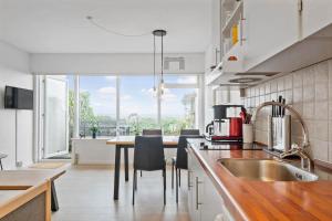 a kitchen with a table and some chairs in it at 0263-Romo-Lyngvejen-99-Ap-28 in Høm