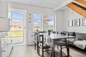 a kitchen and dining room with a table and chairs at 0456-Romo-Vestergade-227-Ap-15 in Høm