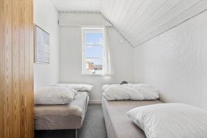 two beds in a room with a window at 0456-Romo-Vestergade-227-Ap-15 in Høm +27 photos