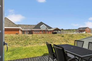 a patio with a table and chairs in front of a house at 0456-Romo-Vestergade-227-Ap-15 in Høm