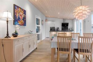 a kitchen and dining room with a table and chairs at 0347-Romo-Vestergade-353 in Høm