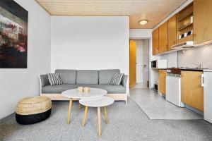 a living room with a couch and a table at 0265-Romo-Lyngvejen-99-Ap-18 in Høm